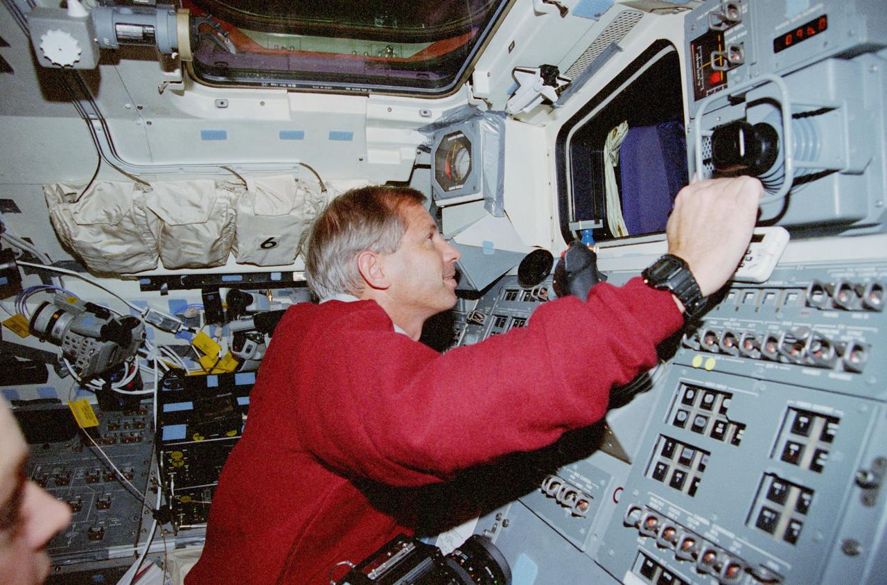 STS080-334-002 (19 Nov.-7 Dec. 1996) --- Astronaut Kenneth D. Cockrell, STS-80 mission commander, looks through a window on the space shuttle Columbia's aft flight deck during rendezvous operations with the Wake Shield Facility (WSF).