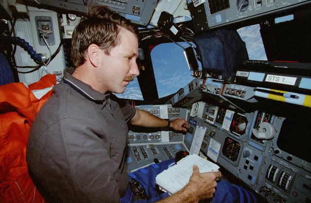 NASA image: Rominger conducts a burn from the commander's forward flight deck station