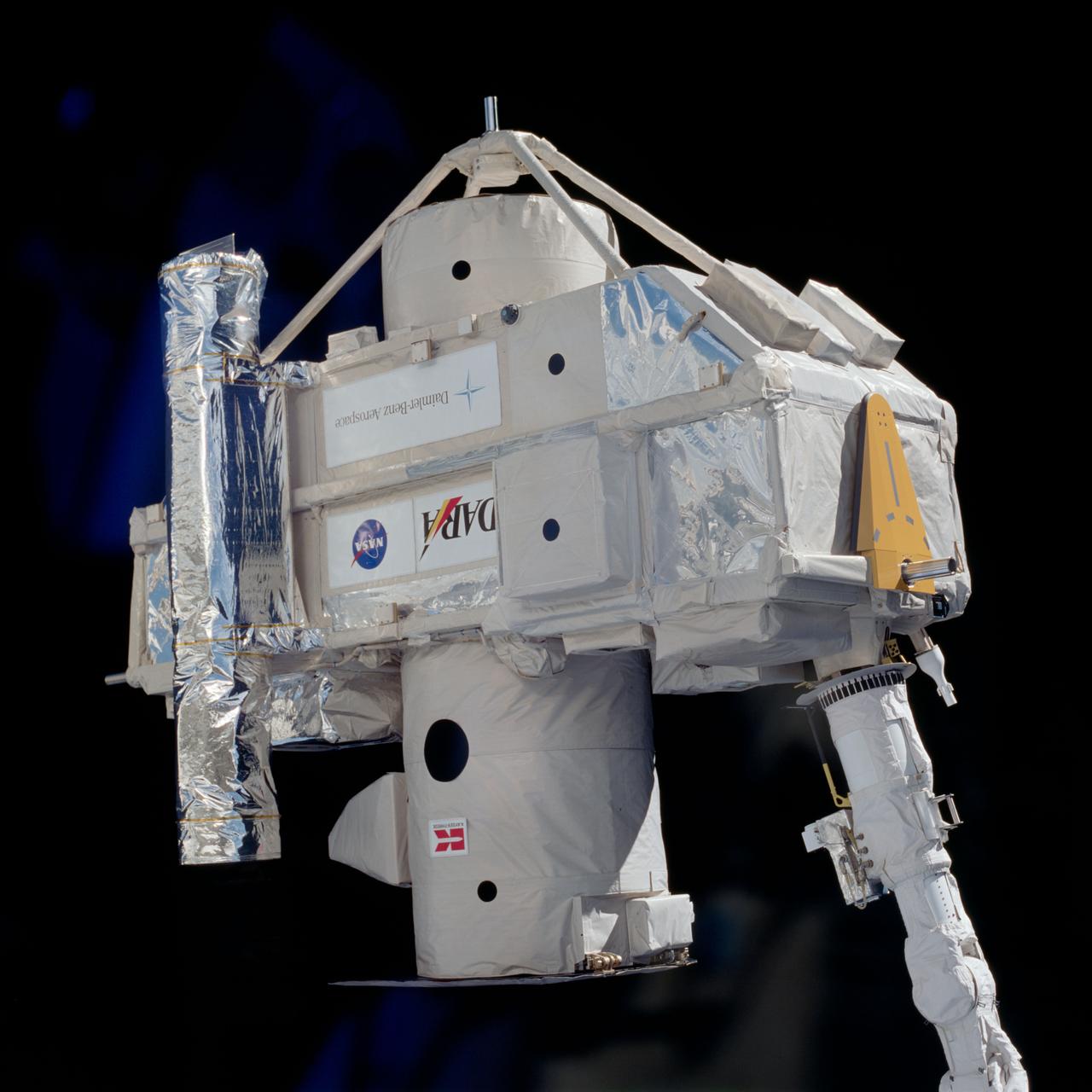 STS080-704-008 (19 Nov.-7 Dec. 1996) --- Backdropped against the blackness of space, the ORPHEUS - Shuttle Pallet Satellite (SPAS) spacecraft is held in the grasp of the space shuttle Columbia's Remote Manipulator System (RMS) during deploy operations in Earth-orbit.