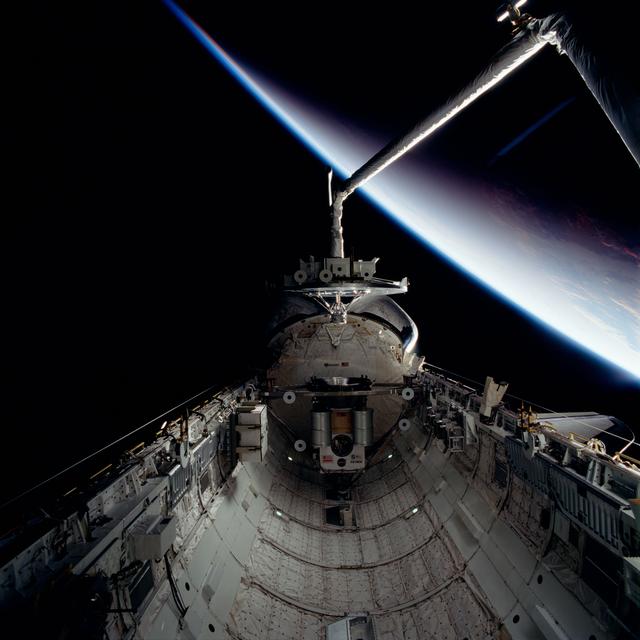NASA image: WSF, RMS arm holds satellite over payload bay