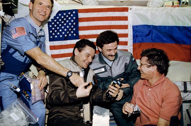 NASA image: STS-81 and Mir 22 crews exchange gifts in the Mir Base Block