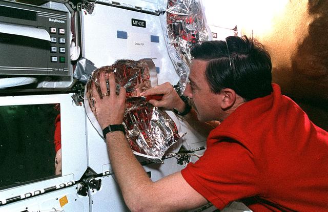 NASA image: Horowitz fashions MLI patches on Flight Day 7