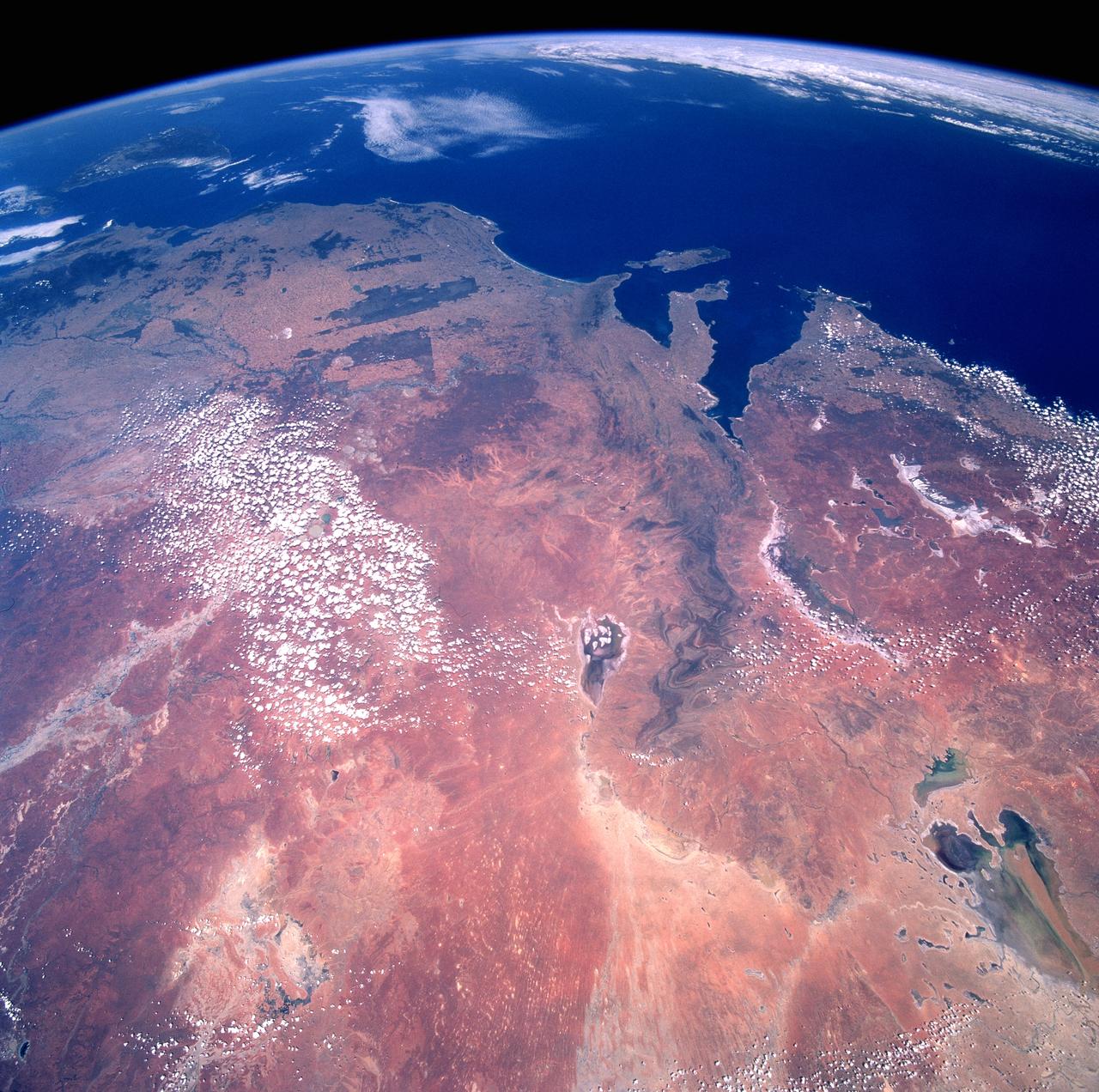 STS082-710-028 (11-21 Feb. 1997) --- Southeastern Australia, looking southeast, from greater-than-usual altitudes: the view stretches from Lake Eyre (bottom right) -- which has an unusual amount of water after heavy rains in Australia's central desert -- all the way to Port Phillip Bay (top left) where the city of Melbourne is located.  This view includes more than half of the state of South Australia (right), all of Victoria (top) and half of New South Wales.  The boot-shaped peninsula top is the Yorke Peninsula, with Kangaroo Island beyond (south).  Remnants of the dark green natural vegetation appear top left, most having been cleared for agriculture.