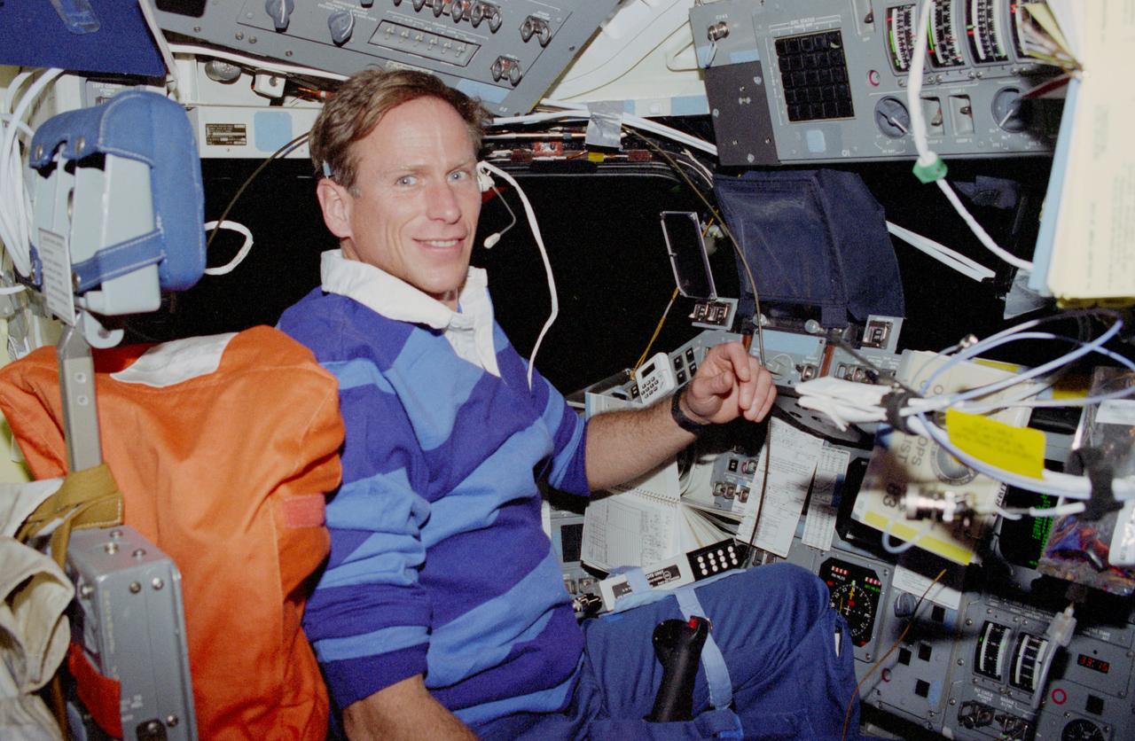 STS083-305-006 (4-8 April 1997) --- Astronaut Michael L. Gernhardt, mission specialist, talks to ground controllers while temporarily occupying the commander's station on the forward flight deck of the Earth-orbiting Space Shuttle Columbia.  Crewed by Gernhardt, four other NASA astronauts and two payload specialists, the scheduled 16-day Microgravity Science Mission (MSL-1) mission was later cut short by a power shortage.