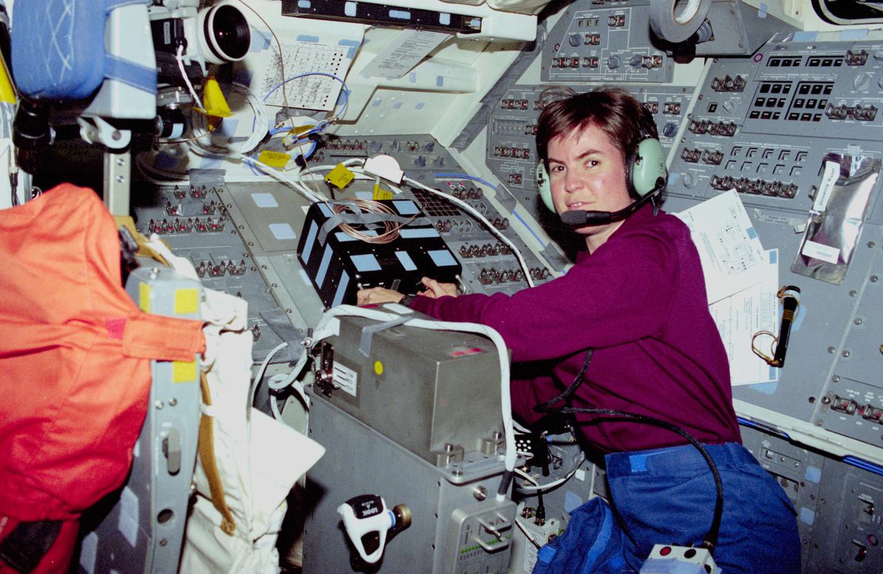 STS083-305-010 (4-8 April 1997) --- Astronaut Janice E. Voss, mission specialist, works with communications systems on the aft flight deck of the Earth-orbiting Space Shuttle Columbia.  Voss, along with five other NASA astronauts and two payload specialist supporting the Microgravity Sciences Laboratory (MSL-1) mission, were less than a fourth of the way through a scheduled 16-day flight when a power problem cut short their planned stay.