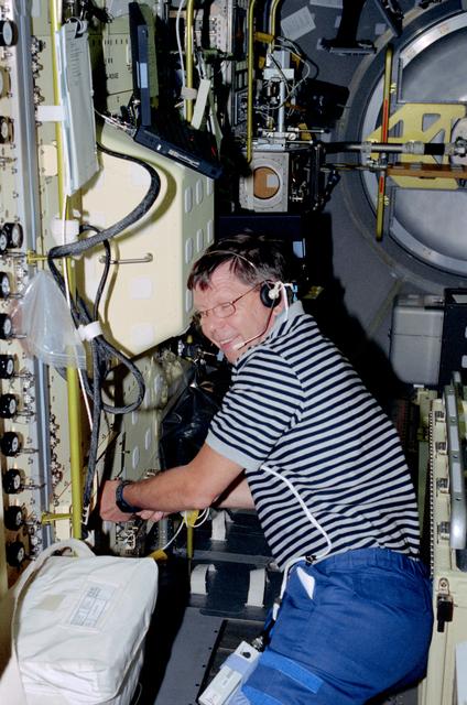 NASA image: CM-1 - PS Crouch in front of rack
