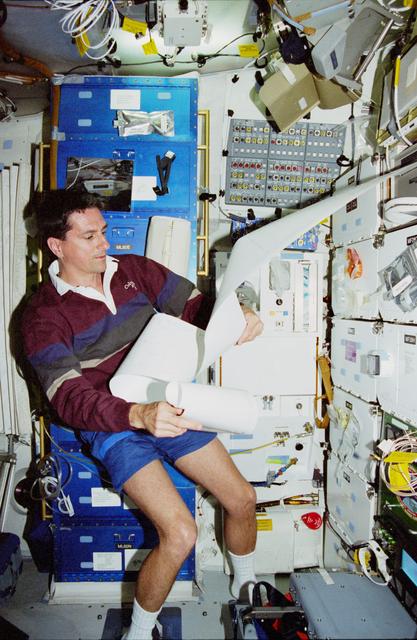 NASA image: MS Thomas on middeck with TIPS messages