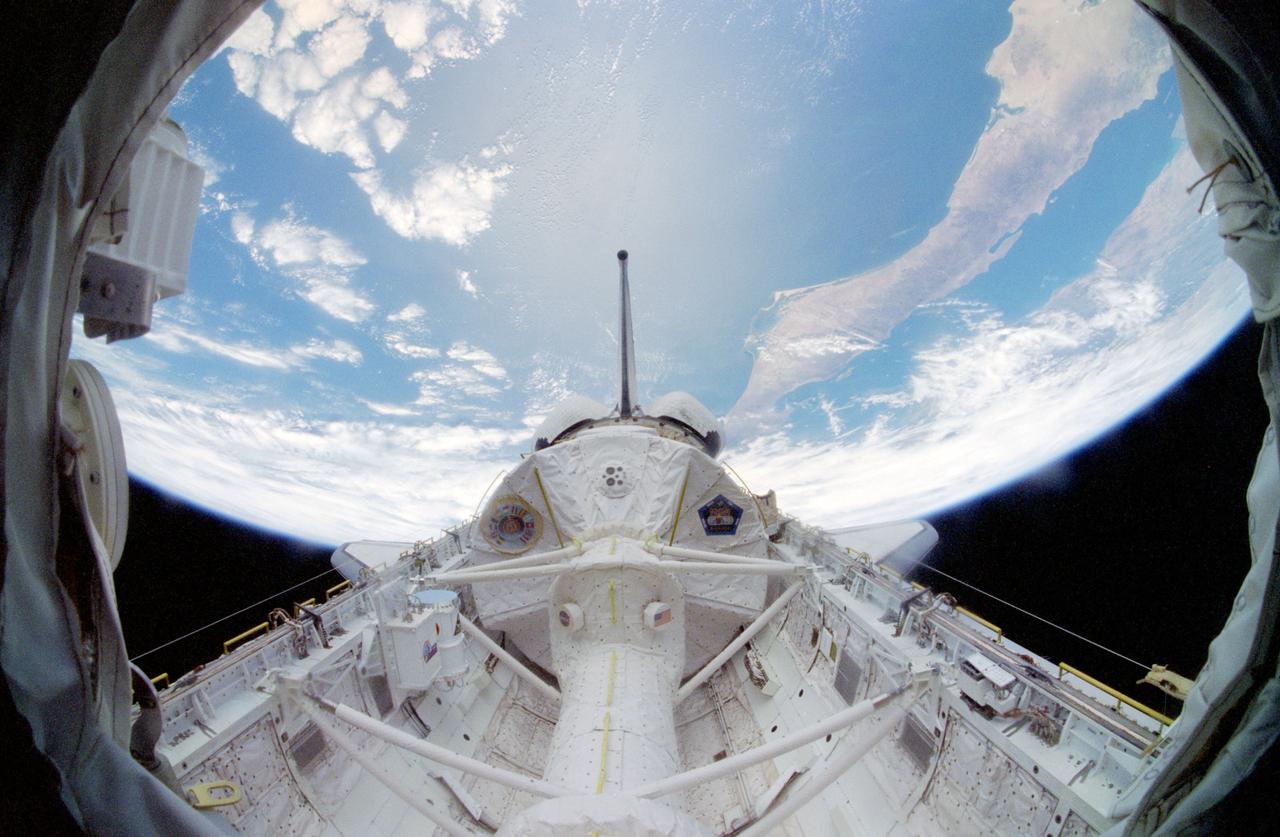 STS083-482-034 (4-8 April 1997) --- A special lens on a 35mm camera gives a "fish-eye" effect this view of the Spacelab Module backdropped over the Pacific Ocean. Nearly all of Baja California and part of western Mexico can be seen at left. Five NASA astronauts and two scientist payload specialists were scheduled to spend 16-days in Earth-orbit but came home early when a problem with one of three fuel cells was recognized.