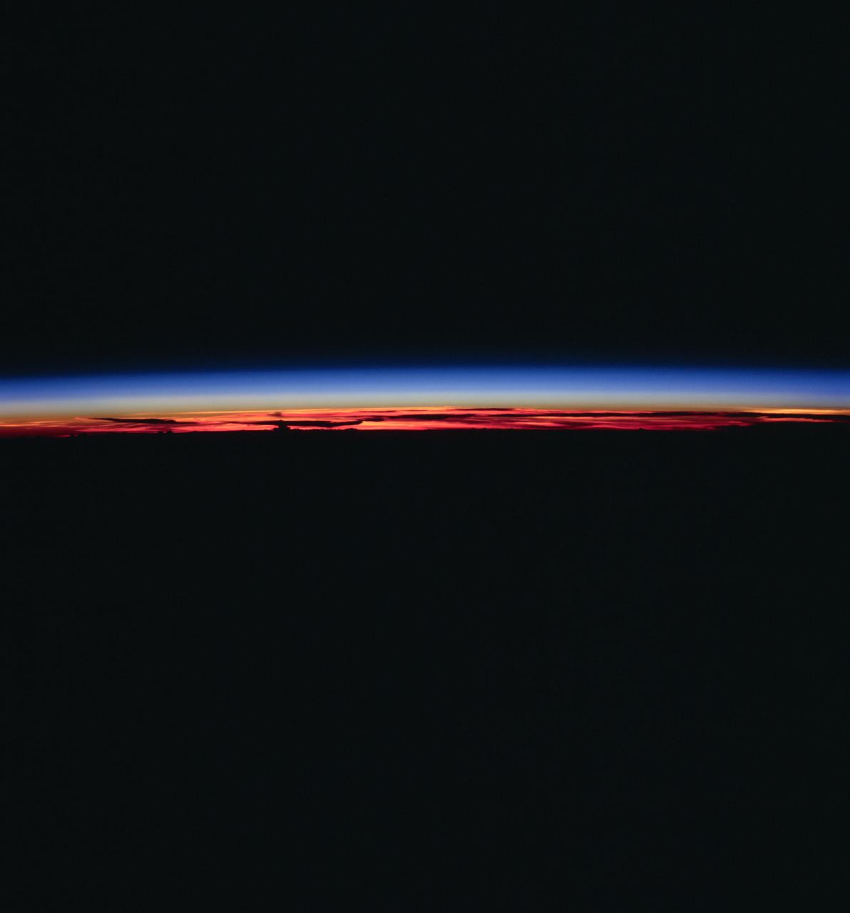 STS083-748-006 (4-8 April 1997) --- This type of scene is seen about every 45 minutes as the astronauts travel around the world. Sunrises and sunsets differ in structure, since the tropopause altitude and atmospheric lamina temperatures vary with time of day, season, and latitude. Close analysis of these terminator photographs provide counts of the number and spacing of atmospheric laminae. In the photographs, as many as 4 laminae have been noted in the normally red-to-orange troposphere, and up to 12 laminae have been counted in the blue upper atmosphere. However, true replication of human vision is not possible using present films. For instance, while on orbit, one astronaut counted 22 layers. The photograph of that event recorded only 8 such layers.