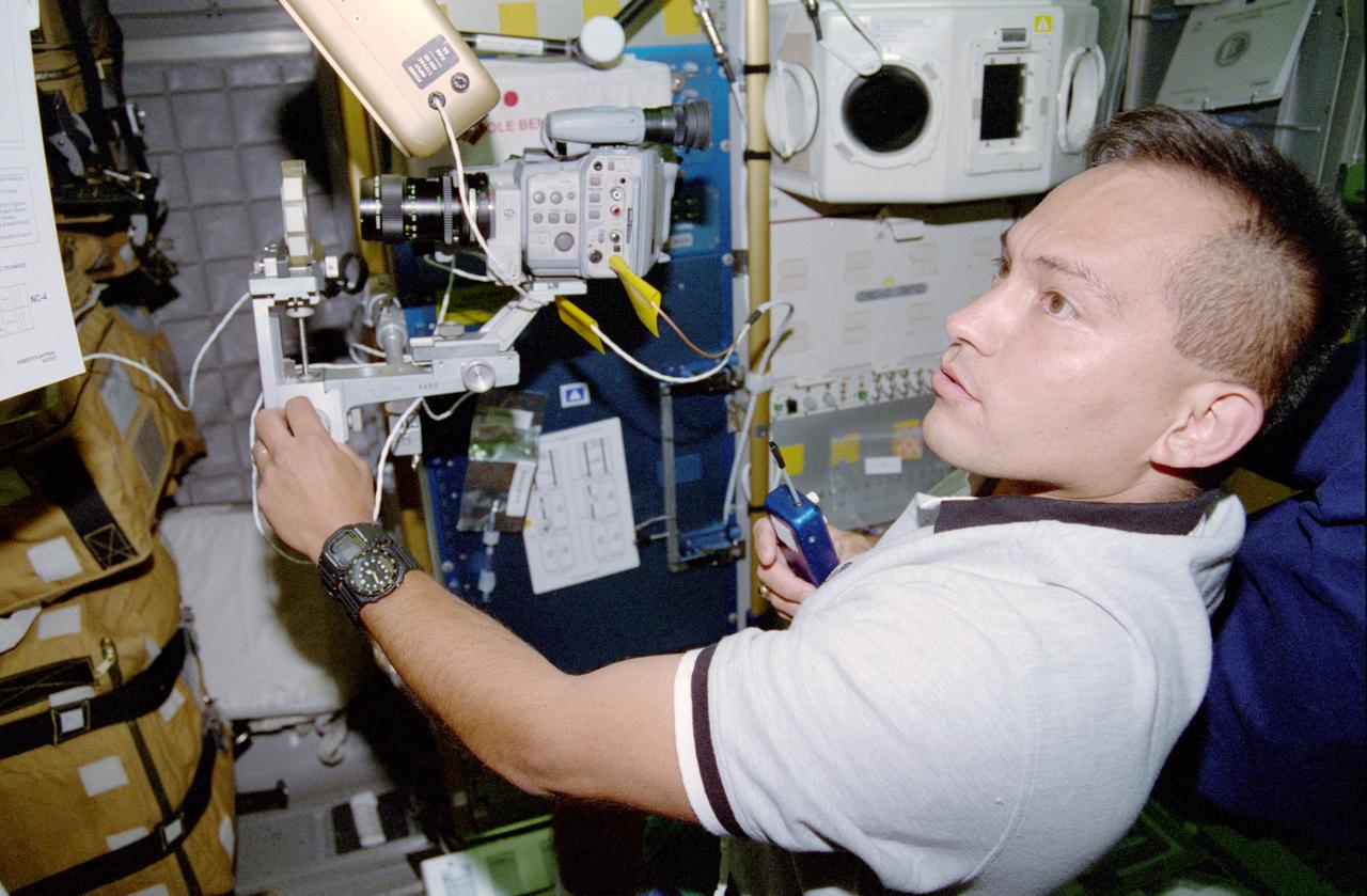 STS084-311-016 (15-24 May 1997) --- Astronaut Carlos I. Noriega, STS-84 mission specialist, videotapes a spore sample for the Real-Time Radiation Measurement Experiment (RRMD), an intravehicular radiation environment measurement experiment.  Noriega is onboard the Spacehab Double Module (DM) located in the cargo bay of the Earth-orbiting Space Shuttle Atlantis.