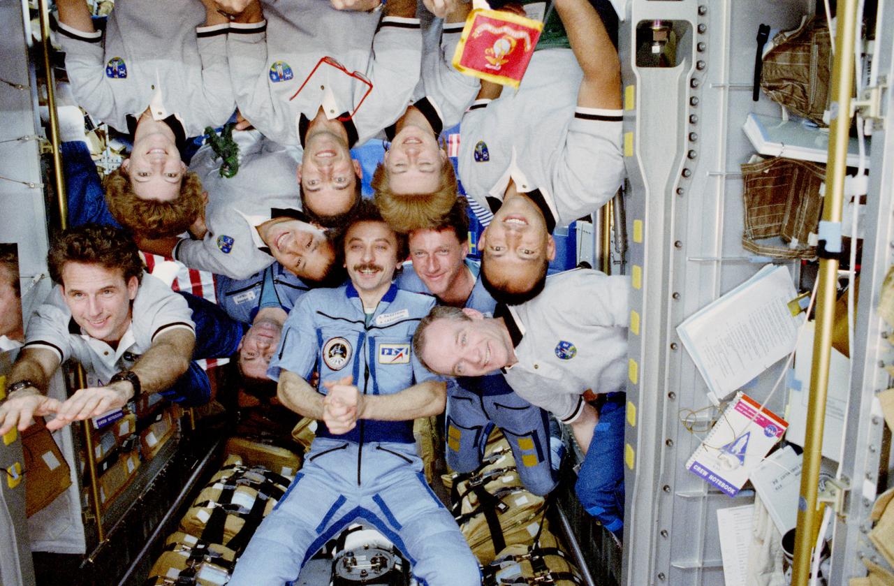 STS084-380-019 (15-24 May 1997) --- In the last minutes of joint activity between the STS-84 and Russian Space Agency (RSA) Mir-23 crews, ten astronauts and cosmonauts pose for an in-space portrait in the Space Shuttle Atlantis Spacehab Double Module (DM).  For orientation purposes, photo should be held with clasped hands of Aleksandr I. Lazutkin (wearing Mir-23 suit) just below center.  The flight engineer is flanked by similarly attired crew mates Vasili Tsibliyev, Mir-23 commander, on the left, and C. Michael Foale, cosmonaut guest researcher, on the right.  The STS-84 crew members are, clockwise from the left, Jerry M. Linenger, mission specialist; Eileen M. Collins, pilot; Edward T. Lu, mission specialist; Jean-Fran?ois Clervoy, payload commander; Elena V. Kondakova and Carlos I. Noriega, both mission specialists, along with Charles J. Precourt, mission commander.