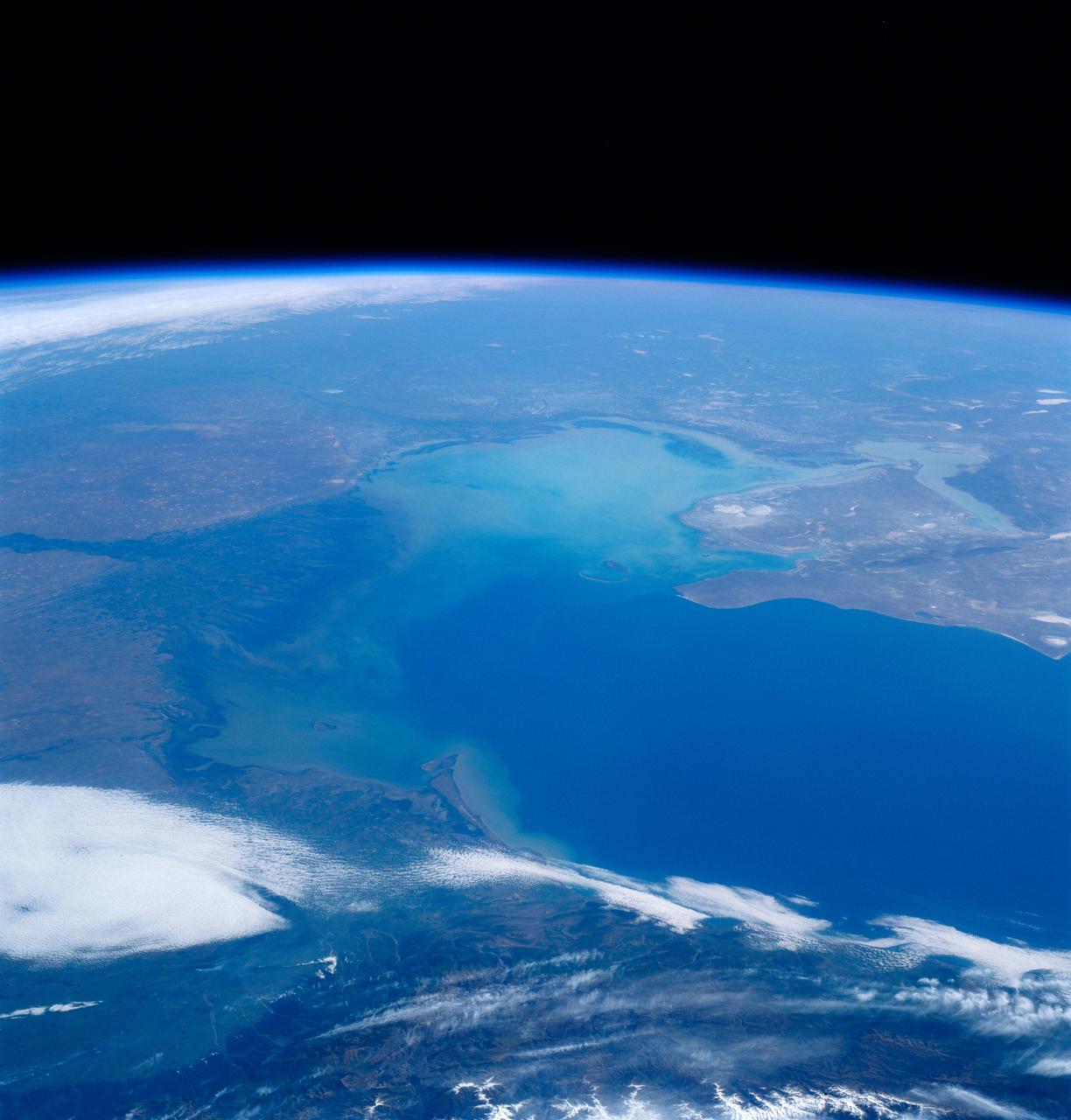 STS084-701-026 (15-24 May 1997) --- The Volga River enters the Caspian, the world's largest inland sea, from the north in this high oblique view. The Volga, the principle waterway of western Russian, is considered the historic cradle of Russia. The Ural River, east of the Volga, also enters the northern part of the Caspian. The dimensions of the Caspian are 1,200 kilometers (750 miles) from north to south, but averages 320 kilometers (200 miles) in width. Oil and natural gas are this regions most important resources.