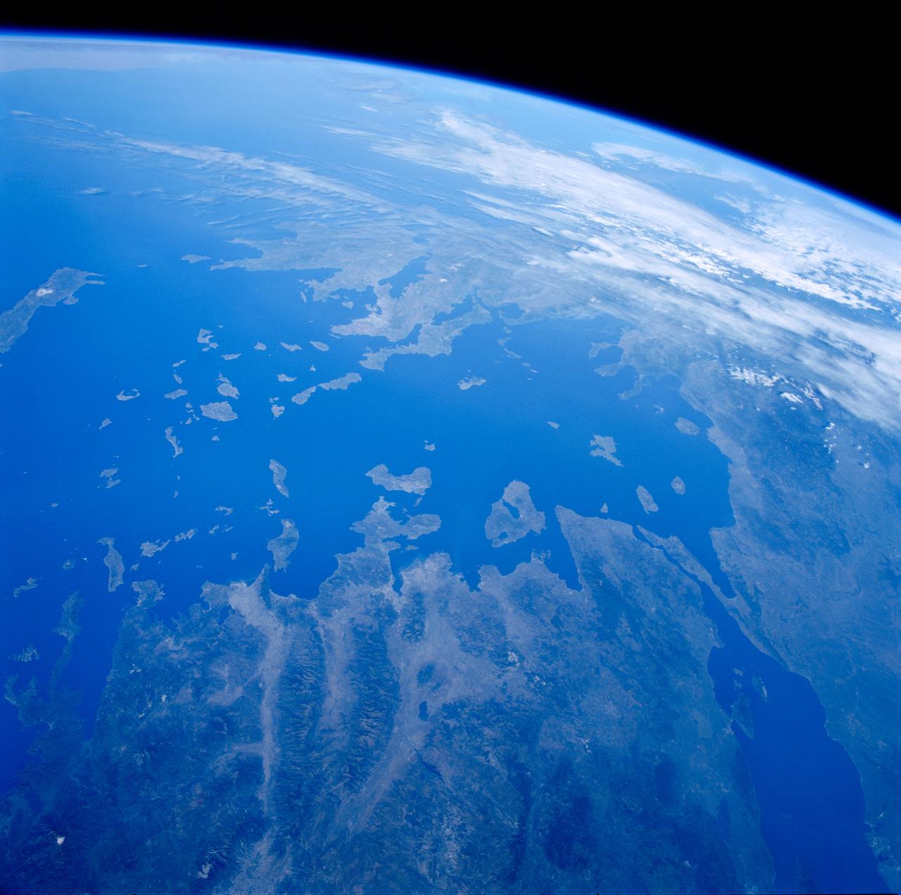 STS084-707-013 (15-24 May 1997) --- As photographed from the Earth-orbiting Space Shuttle Atlantis, this 70mm scene provides a modern view from space of a region rich in ancient history. The Minoan civilization thrived on Crete (western end of the island is visible on the left side of the image) from 3000 BC to about 1100 BC.  It is believed by some historians that the eruption of the volcanic island of Thera (the "C" shaped island facing Crete) and possible tsunami helped to bring about the end of the Minoan civilization. The next great civilization to emerge was that of the Greeks. One of the most prominent city-states was Athens which can be seen as a light colored area on an elongated piece of land at center of view (near the clouds). The Aegean Sea separates Greece from Asia Minor (Turkey) in the foreground.