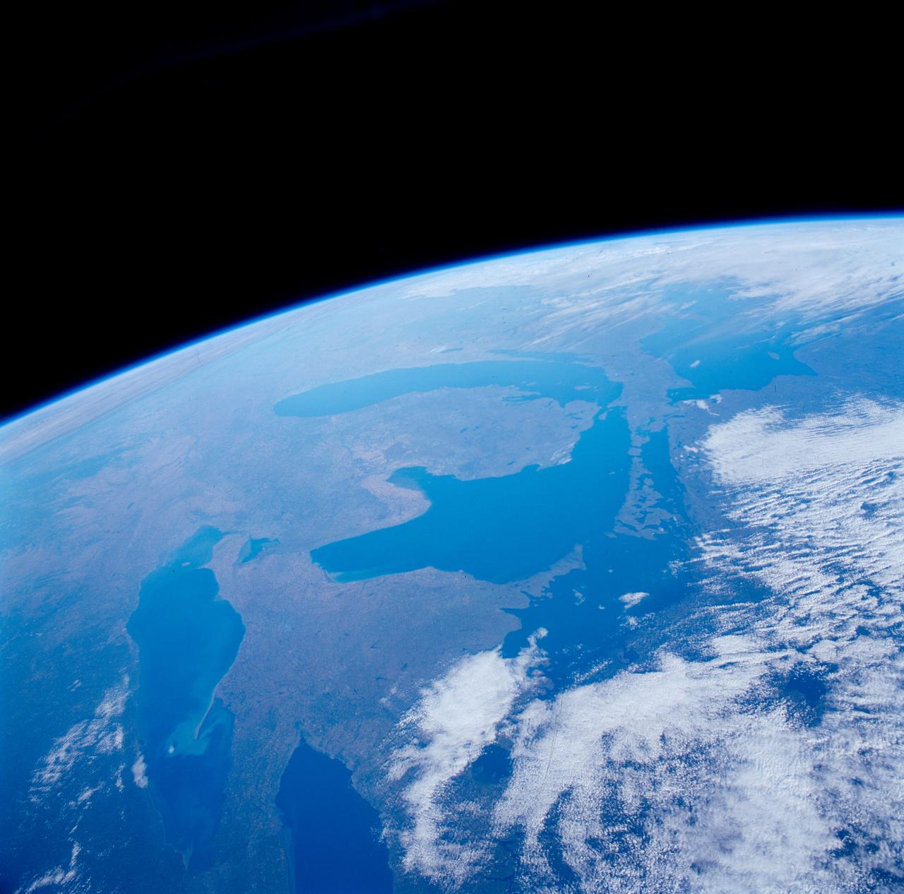 STS084-710-098 (15-24 May 1997) --- A rare view of the Great Lakes captured in one frame. The Great Lakes region is home to 8.5 million Canadians and 32.5 million Americans. At center is Lake Huron and Georgian Bay. Above Lake Huron and towards the horizon is Lake Michigan, the only Great Lake to be located entirely within the United States. To the right of Lake Michigan, and partially under clouds, is Lake Superior the second largest lake in the world after the Caspian Sea. Lake Erie is located to the left of Lake Huron. Next to Lake Erie is Lake Ontario. According to geologists, the Great Lakes were created by glacial processes that began about 1,000,000 years ago.