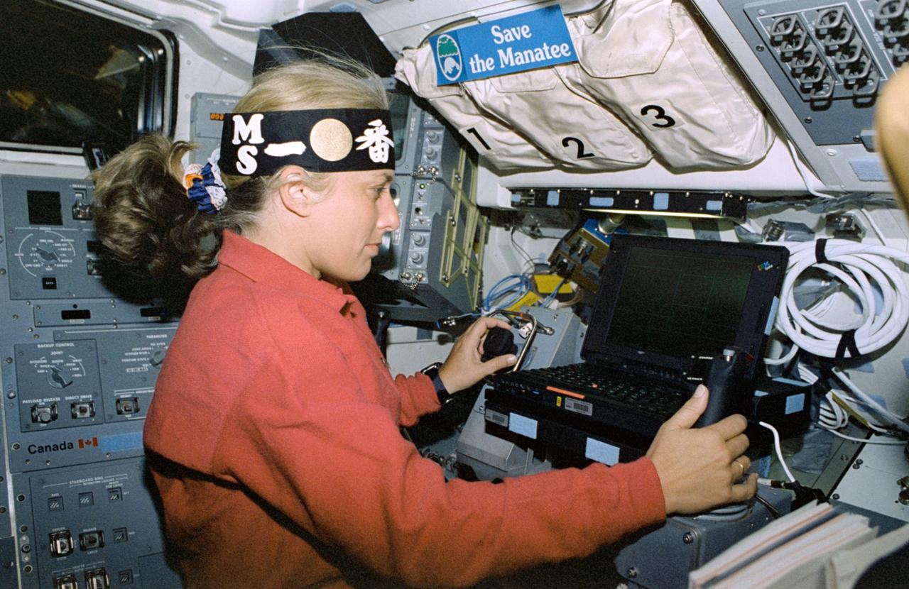STS085-316-026 (7 - 19 August 1997) --- Wearing a head band representing the Manipulator Flight Demonstration (MFD) hardware several feet away in the open cargo bay of the Space Shuttle Discovery, astronaut N. Jan Davis, payload commander, performs MFD operations at the experiment's work station. This flight of the MFD is in preparation for the Japanese Experiment Module (JEM) Remote Manipulator System (RMS) Small Fine Arm (SFA).