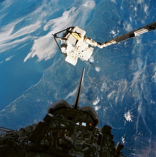 NASA image: CRISTA-SPAS, held over the payload bay by the RMS after rendezvous and capture