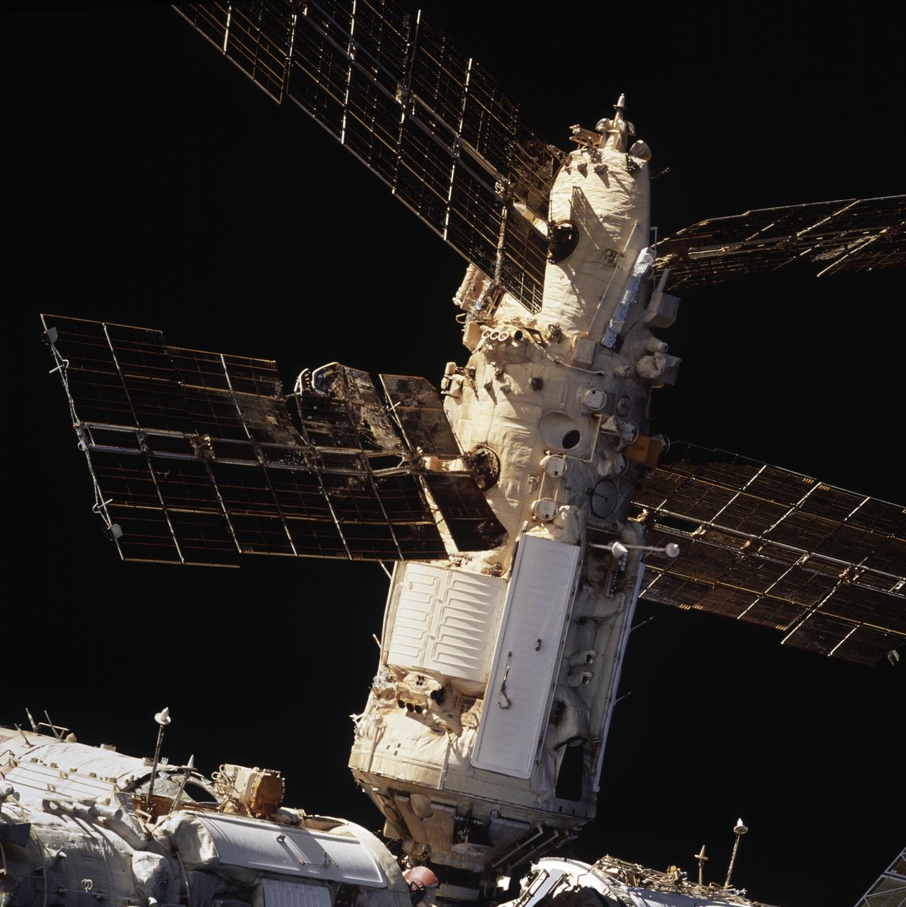 STS086-720-007 (25 Sept.-6 Oct. 1997) --- A 70mm view of Russia’s Mir Space Station’s Spektr Module shows the backside of a solar array panel and damage incurred by the impact of a Russian unmanned Progress re-supply ship which collided with the space station on June 25, 1997, causing Spektr to depressurize.  A radiator, which also was struck by the Progress, is out of view from this angle. Photo credit: NASA