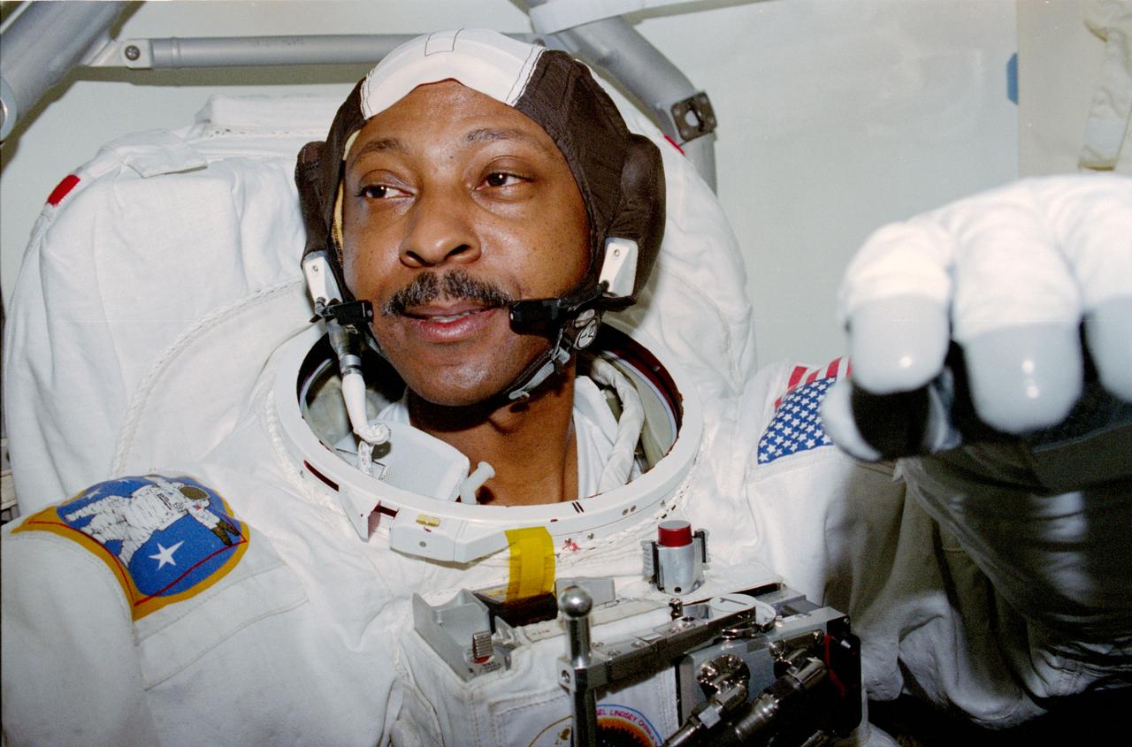 STS087-317-036 (19 November – 5 December 1997) --- Astronaut Winston E. Scott, mission specialist, goes through final touches of space suit donning in preparation for one of two extravehicular activities (EVA) he performed in and around the cargo bay of the Space Shuttle Columbia. Scott was joined by astronaut Takao Doi, an international mission specialist representing Japan's National Space Development Agency (NASDA), on both EVAs.