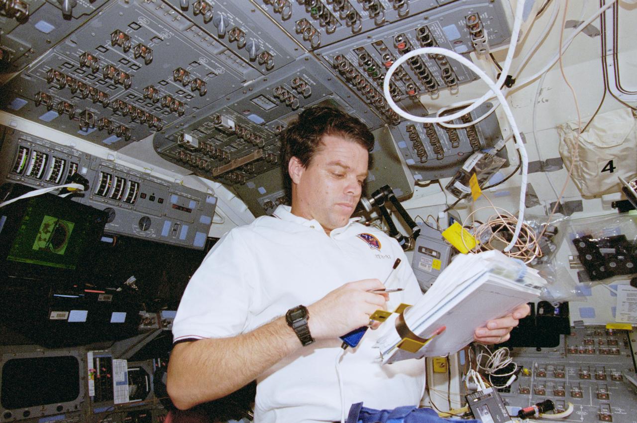 STS087-352-008 (19 November - 5 December 1997) --- Astronaut Kevin R. Kregel, mission commander, looks over the mission flight plan on the forward flight deck of the Space Shuttle Columbia.  Kregel was accompanied by four other astronauts and a Ukrainian payload specialist for 16-days in space in support of the United States Microgravity Payload (USMP-4) mission.