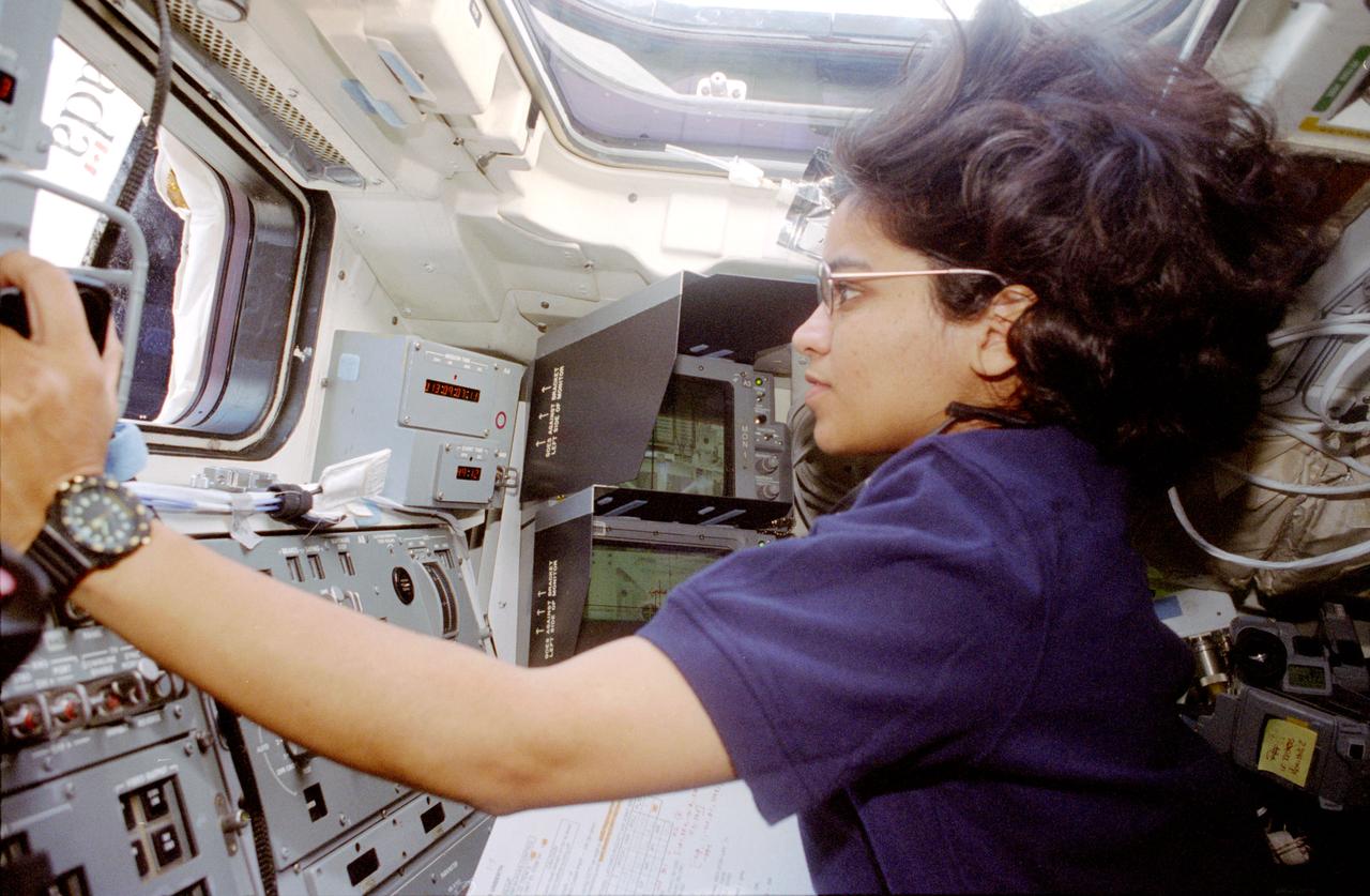 STS087-357-019 (19 November - 5 December 1997) --- Astronaut Kalpana Chawla, mission specialist, operates Columbia's Remote Manipulator System (RMS) on the aft flight deck during operations with the Spartan 201 satellite.  Chawla joined four other astronauts and a Ukrainian payload specialist for 16-days of research in Earth-orbit in support of the United States Microgravity Payload 4 (USMP-4) mission.