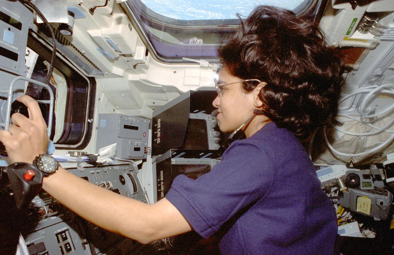 STS087-357-022 (19 November &#0150; 5 December 1997) --- Astronaut Kalpana Chawla, mission specialist, operates the Space Shuttle Columbia's Remote Manipulator System (RMS) on the aft flight deck during operations with the Spartan 201 satellite.  Kalpana Chawla joined four other astronauts and a Ukrainian payload specialist for 16-days of research in Earth-orbit in support of the United States Microgravity Payload 4 (USMP-4) mission.  The light blue and white colors associated with the crew's nearby home planet are visible in the overhead window.