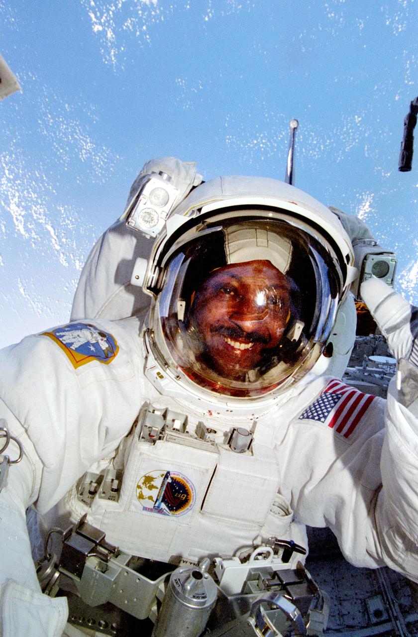 STS087-375-015 (19 November – 5 December 1997) --- Astronaut Winston E. Scott, mission specialist, during one of two extravehicular activities (EVA) in the cargo bay of the Earth-orbiting Space Shuttle Columbia, is backdropped against a blue “blanket” of ocean water. This view was taken with a 35mm camera.