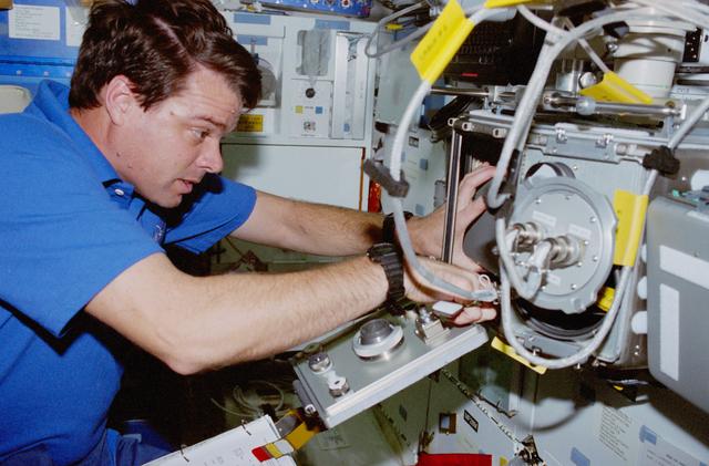 NASA image: USMP-4 MGBX, Kregel sets up glovebox