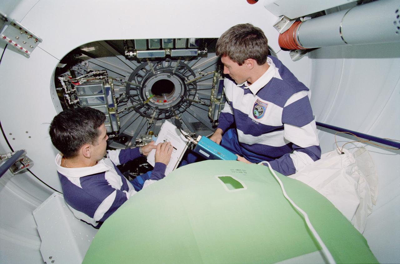 STS088-322-021  (4-15  DECEMBER 1998) --- Astronaut Robert D. Cabana (left), mission commander, and cosmonaut Sergei K. Krikalev, mission specialist representing the Russian Space Agency (RSA), plan their approach to tasks in the U.S.-built Unity module.  All six STS-88 crew members were involved in tasks to ready Unity and the now-connected Russian-built FGB module, also called Zarya, for their International Space Station (ISS) roles.  Krikalev has been named as a member of the first ISS crew.