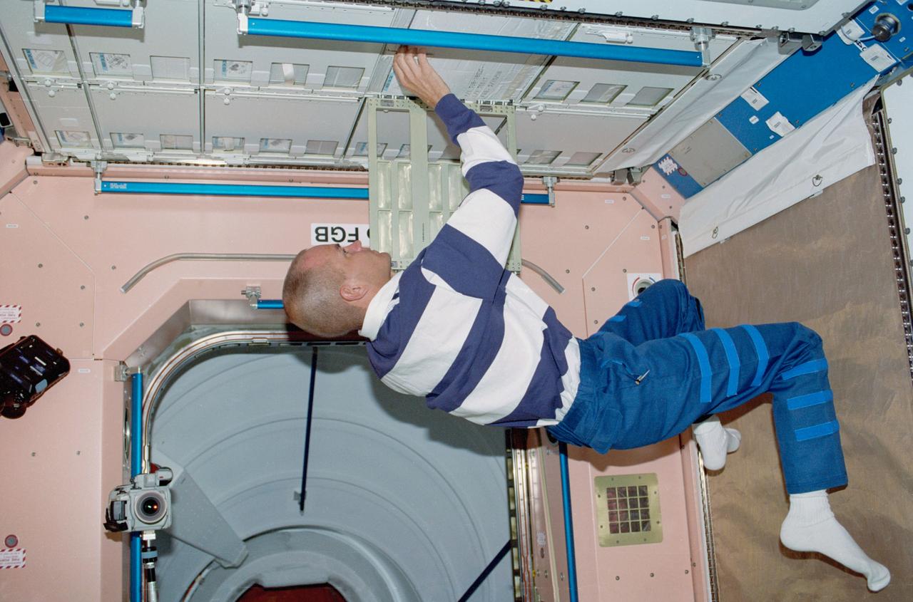 STS088-334-012  (4-15 Dec. 1998) --- Astronaut Frederick W. Sturckow, pilot, works with furnishings on the U.S.-built Unity module as he and five crew mates teamed up to  prepare Unity and the connected Russian-built Zarya module for their International Space Station (ISS) roles.