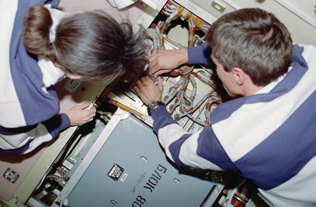 NASA image: Krikalev and Currie perform an IFM on a battery recharger in the FGB/Zarya