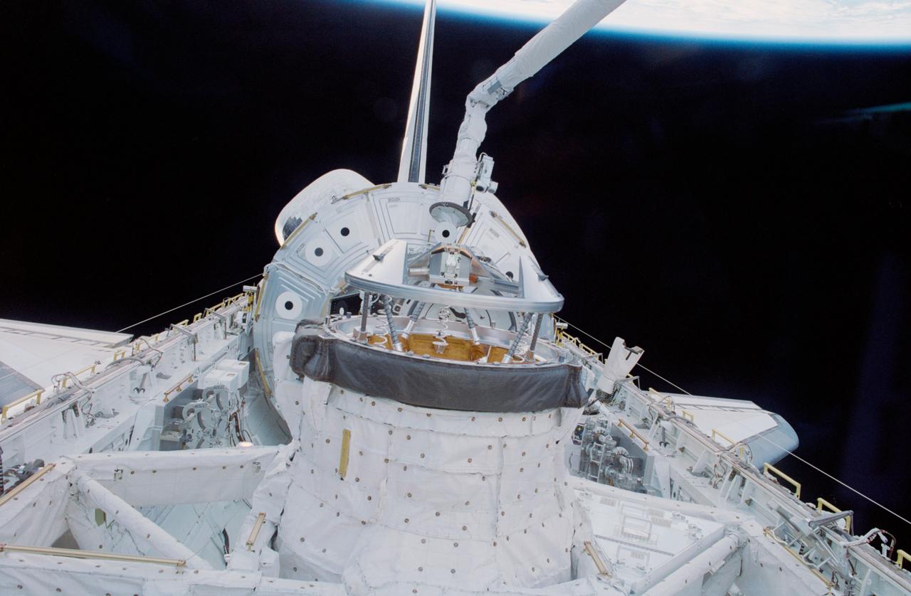 STS088-361-021 (4-15 Dec. 1998) --- The Canadian-built Remote Manipulator System (RMS) arm is about to grapple the Node 1 or Unity Module for mating to the Space Shuttle Endeavour.  The move marked the first of many steps that allowed the United States-built Unity Module to be docked with the Russian-built FGB or Zarya Module later in the mission.