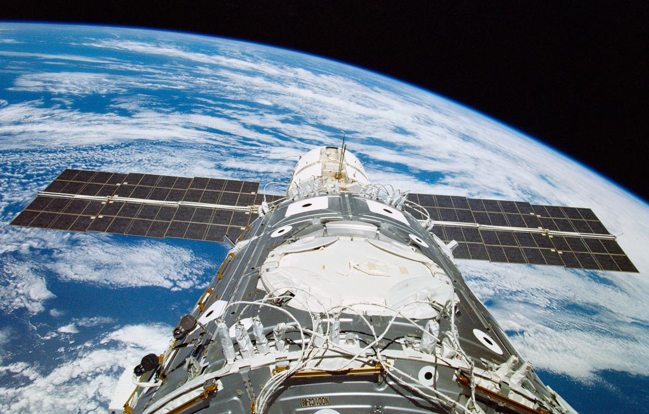 STS088-363-023 (4-15 Dec. 1998) --- Wires and cables on the Unity module (foreground) are telltale clues that the space walking astronauts of STS-88 had performed their first extravehicular activity (EVA) when this 35mm frame was exposed from the aft windows of Endeavour. The Zarya module can be seen mated to the top end of Unity.