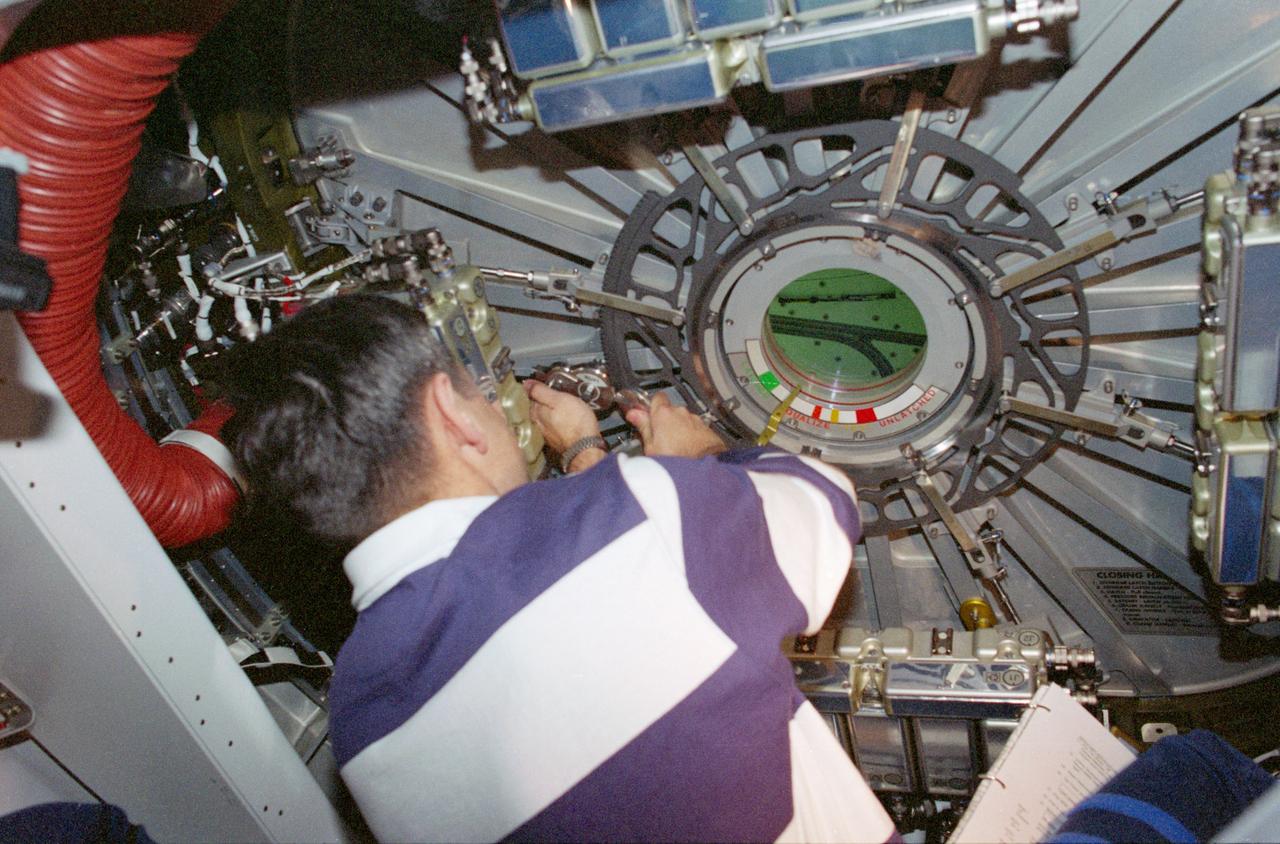 STS088-370-014 (4-15 Dec. 1998) --- Astronaut Robert D. Cabana, commander, closes the hatch to the International Space Station (ISS) following several days of work by the crew members to ready its first two components (Zarya and Unity Modules).
