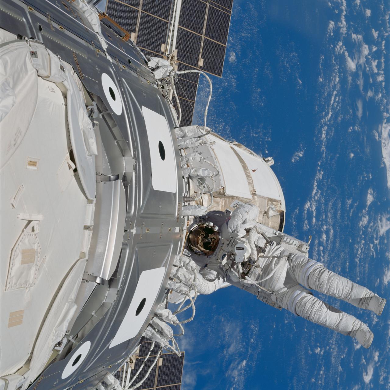 STS088-702-004  (4-15 Dec. 1998) --- Astronaut James H. Newman works on wrap up tasks during the final of three space walks performed by the STS-88 crew during its eleven-day mission in Earth orbit.  Astronaut Jerry L. Ross, Newman's partner on all three of the extravehicular activity (EVA) sessions, is out of frame at left.