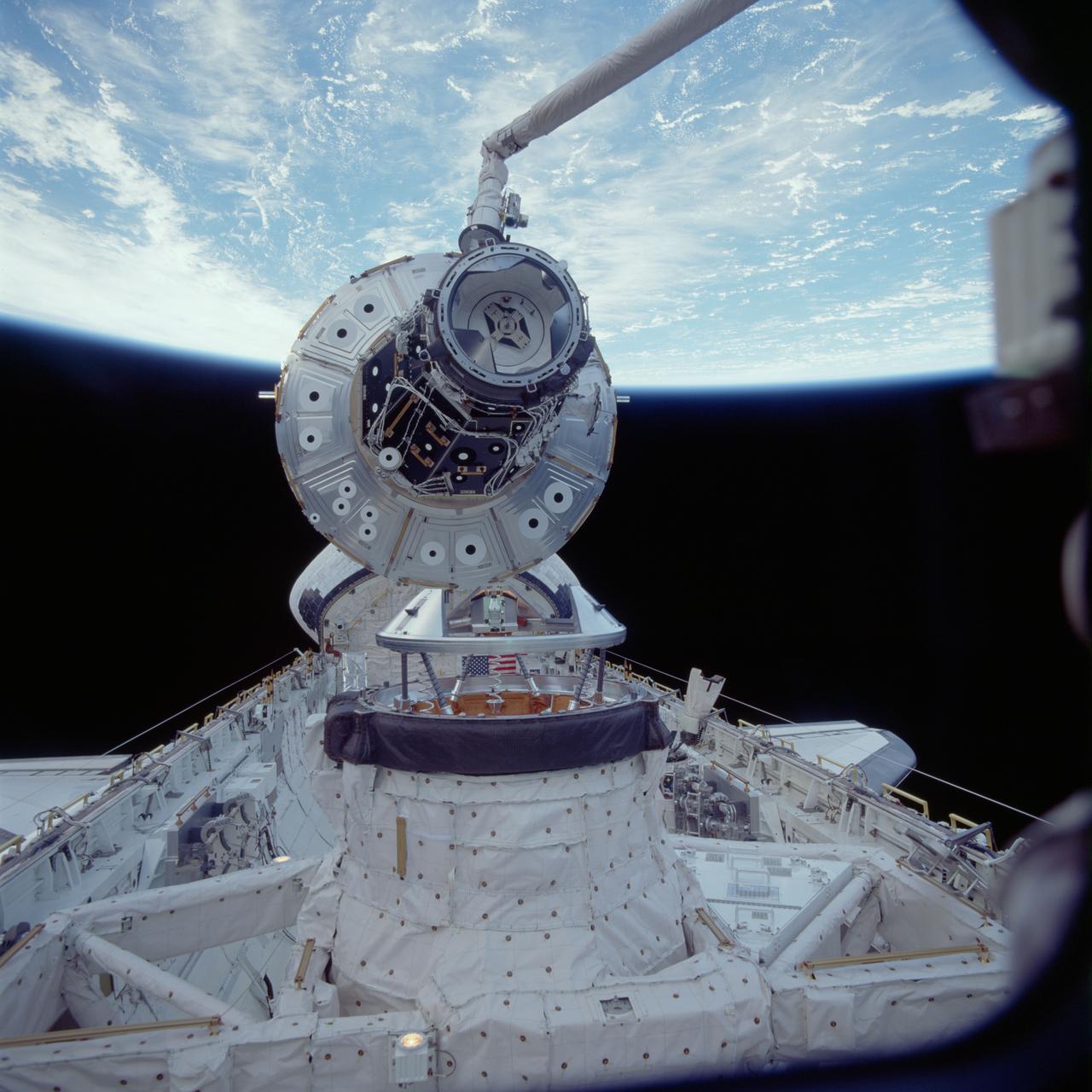 STS088-705-070 (5 Dec. 1998) --- One of the STS-88 astronauts aimed a 70mm camera through Endeavour's aft flight deck windows to record this Dec. 5 image of the Unity connecting module as it was being put into position to be mated to Endeavour's docking system in the cargo bay. The mating was the first link in a long chain of events that led up to the eventual deployment in Earth orbit of the connected Unity and Zarya modules later in the 11-day mission. Photo credit: NASA