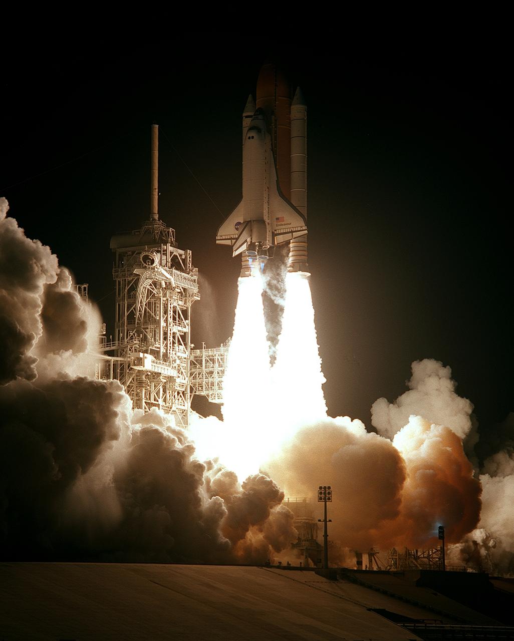 STS088-S-006 (4 Dec. 1998) --- The Space Shuttle Endeavour lights up the night sky as it embarks on the first mission dedicated to the assembly of the International Space Station (ISS).  Liftoff occurred at 3:35:34 a.m. (EST), December 4, 1998, from Launch Pad 39A, at the Kennedy Space Center (KSC), Florida.  Onboard were astronauts Robert D. Cabana, mission commander; Frederick W. Sturckow, pilot; Nancy J. Currie, Jerry L. Ross and James H. Newman, along with Russian Space Agency (RSA) cosmonaut Sergei K. Krikalev, all mission specialists.