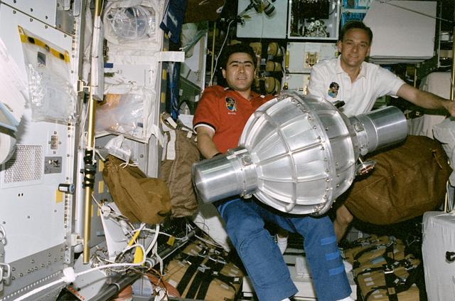 NASA image: STS-89 crewmembers hold a gyrodyne intended for transfer to the Mir