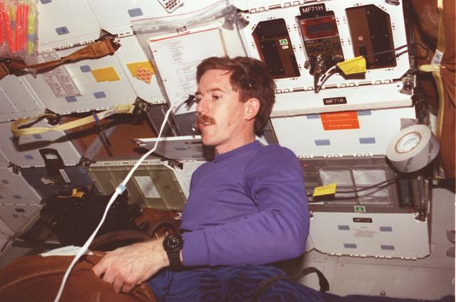 STS089-372-031 (22-31 Jan. 1998) --- Astronaut James F. Reilly, STS-89 mission specialist, tugs on a bag of supplies to be transferred from the space shuttle Endeavour's middeck to Russia's Mir Space Station, to which the shuttle was docked for several days. In the midst of the nine-day flight, Endeavour dropped off a number of supplies for the Mir crew members, along with Andrew S. W. Thomas, cosmonaut guest researcher; and the shuttle crew also retrieved David A. Wolf, who had spent four months on Mir. Photo credit: NASA