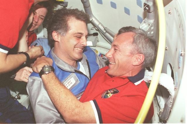 STS089-386-013 (22-31 Jan. 1998) --- Astronaut David A. Wolf, cosmonaut guest researcher, greets Terrence W. Wilcutt, STS-89 shuttle mission commander, and Bonnie J. Dunbar, payload commander, after hatch opening following Russia?s Mir Space Station's and the space shuttle Endeavour's docking.  The greeting kicked off several days of joint activity between the NASA and Mir crew members, during the eighth shuttle/Mir docking mission. Photo credit: NASA