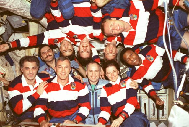 STS089-391-004 (22-31 Jan. 1998) --- Ten astronauts and cosmonauts form a human oval in order to fit into a single frame, onboard Russian Mir Space Station?s Base Block, the traditional in-flight crew portrait.  In conventional position mode (from the left) are David A. Wolf, STS-89 mission specialist and former cosmonaut guest researcher; Pavel V. Vinogradov, Mir-24 flight engineer; Terrence W. Wilcutt, shuttle commander; Anatoly Y. Solovyev, Mir-24 commander; and mission specialist Bonnie J. Dunbar, payload commander. Demonstrating the freedom of microgravity, head-to-head with bottom row, are (from the left) Salizhan S. Sharipov, mission specialist representing Russian Space Agency (RSA); James F. Reilly, mission specialist; and Joe F. Edwards Jr., pilot.  At 90-degree angle poses are Andrew S. W. Thomas, mission specialist and current cosmonaut guest researcher (top); and Michael P. Anderson, mission specialist. Photo credit: NASA