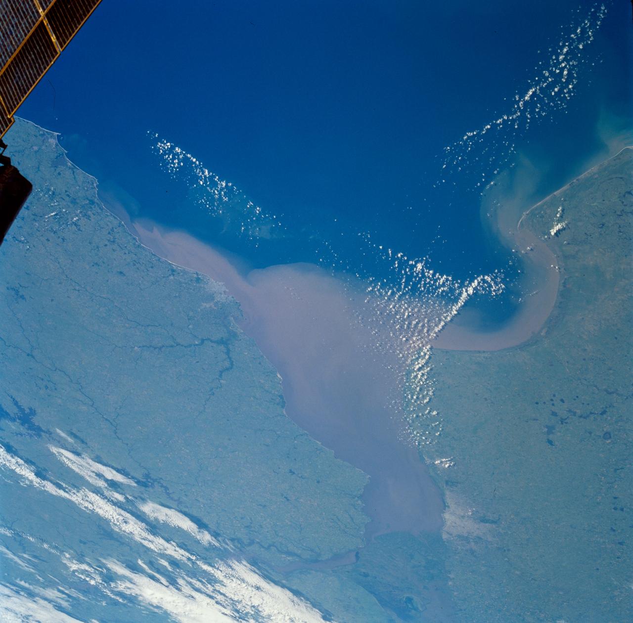 STS089-703-056 (22-31 Jan. 1998) --- This oblique picture of Argentina and other parts of South America was photographed with a 70mm handheld camera from the Earth-orbiting space shuttle Endeavour. Looking westward across the continent, north is toward the upper right corner and the Atlantic Ocean is in the foreground. Rio de la Plata in the center (the confluence of Rio Uruguay and Rio Parana) shows a sediment plume generated by drainage of El Niño rains upslope in the Andean foothills. The sediment plume is possibly more extensive than usual and extends down the coast and out of the bay to the left (south). The city of Buenos Aires, Argentina (population 13 million) is at upper left, and at right center is the city of Montevideo, Uruguay (population 1.2 million). Photo credit: NASA