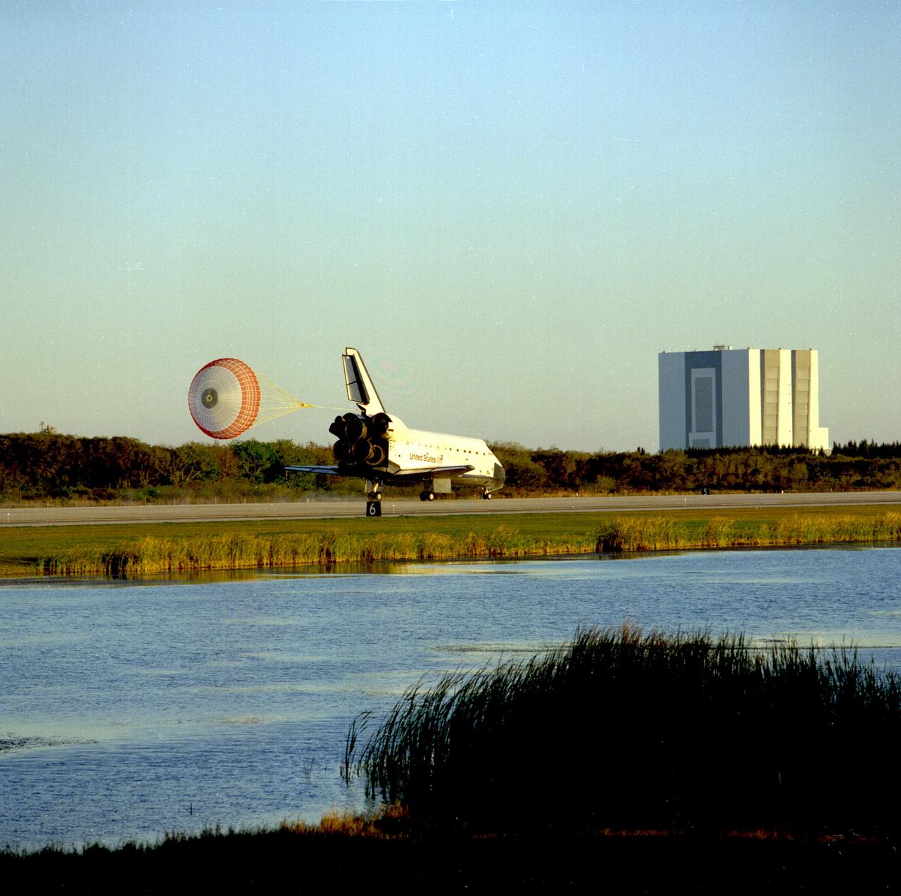 STS089-S-012 (31 Jan. 1998) --- The drag chute on the space shuttle Endeavour is deployed as the spacecraft rolls down Runway 15 of the Shuttle Landing Facility (SLF) to successfully complete an almost-nine-day mission in Earth orbit. Main gear touchdown was at 5:35:09 p.m. (EST) Jan. 31, 1998.  Complete wheel stop occurred at 5:36:19 p.m., making a total mission elapsed time of eight days, 19 hours, 48 minutes and four seconds. The 89th space shuttle mission marked the 42nd (and 13th consecutive) landing of a shuttle at Kennedy Space Center (KSC). Onboard were astronauts Terrence W. Wilcutt, Joe F. Edwards Jr., Bonnie J. Dunbar, David A. Wolf, James F. Reilly and Michael P. Anderson; and the Russian Space Agency's (RSA) cosmonaut Salizhan S. Sharipov. Andrew S. W. Thomas had earlier gone into space aboard the Endeavour to replace Wolf aboard Russia's Mir Space Station. The ninth and final shuttle/Mir docking mission in the spring of this year will retrieve Thomas from the Mir complex. Photo credit: NASA
