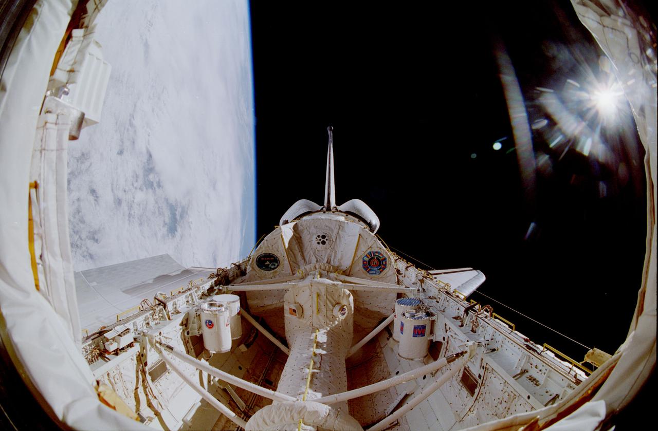STS090-361-022 (17 April - 3 May 1998) --- A special lens on a 35mm camera gives a fish-eye effect to this out-the-window view from the Space Shuttle Columbia's cabin.  The Spacelab Science Module, hosting 16-days of Neurolab research, is in frame center.  This picture clearly depicts the configuration of the tunnel that leads from the cabin to the module in the center of the cargo bay.
