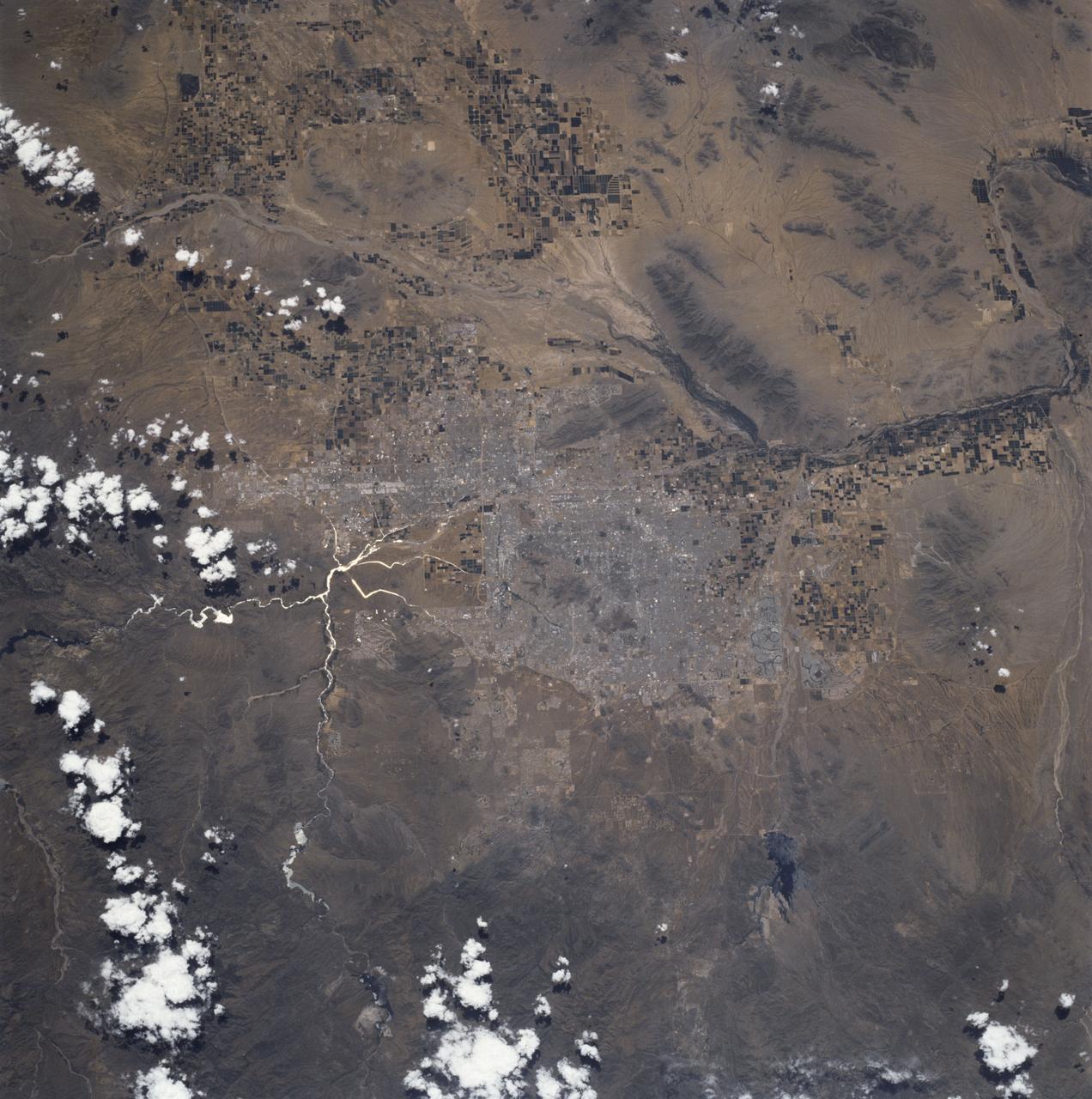 STS090-736-037 (17 April - 3 May 1998) --- Phoenix, Arizona as photographed with a 70mm handheld camera from the Earth-orbiting Space Shuttle Columbia.  Sunglint makes canals and pools very easily identifiable in the frame.  Minimal cloud cover during the 16-day Neurolab mission and the flight track of Columbia opened the way for the crew members to photograph more North American cities than most Shuttle missions.