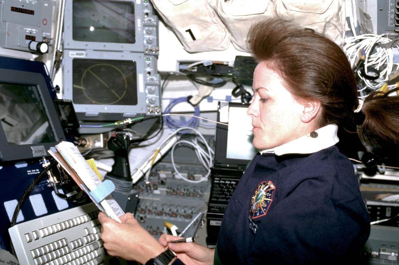 STS091-349-005 (2-12 June 1998) --- Astronaut Janet L. Kavandi, mission specialist, performs a check of the Orbiter Space Vision Systems (OSVS) on the flight deck of the Earth-orbiting Space Shuttle Discovery.