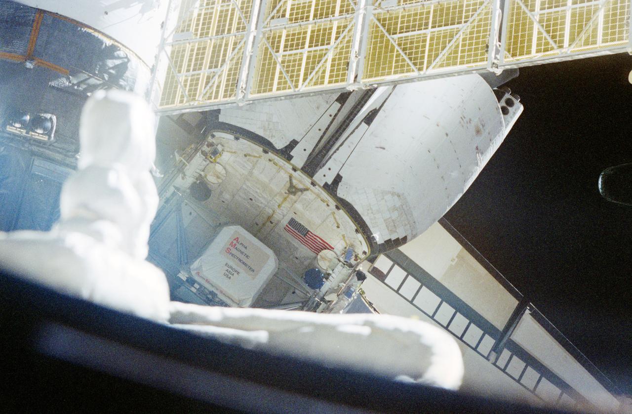 STS091-367-033 (2-12 June 1998) --- This photo of the Space Shuttle Discovery's aft section features the Alpha Magnetic Spectrometer (AMS), as seen from Russia's Mir space station, docked with Discovery at the time.  AMS is the first  large-magnet experiment ever placed in Earth orbit.  The scientific goal of this high-energy physics experiment is to increase our understanding of the composition and origin of the universe.  It is designed to search for and measure charged particles, including antimatter, outside Earth's atmosphere.  The charge of such particles can be identified only by their trajectories in a magnetic field.