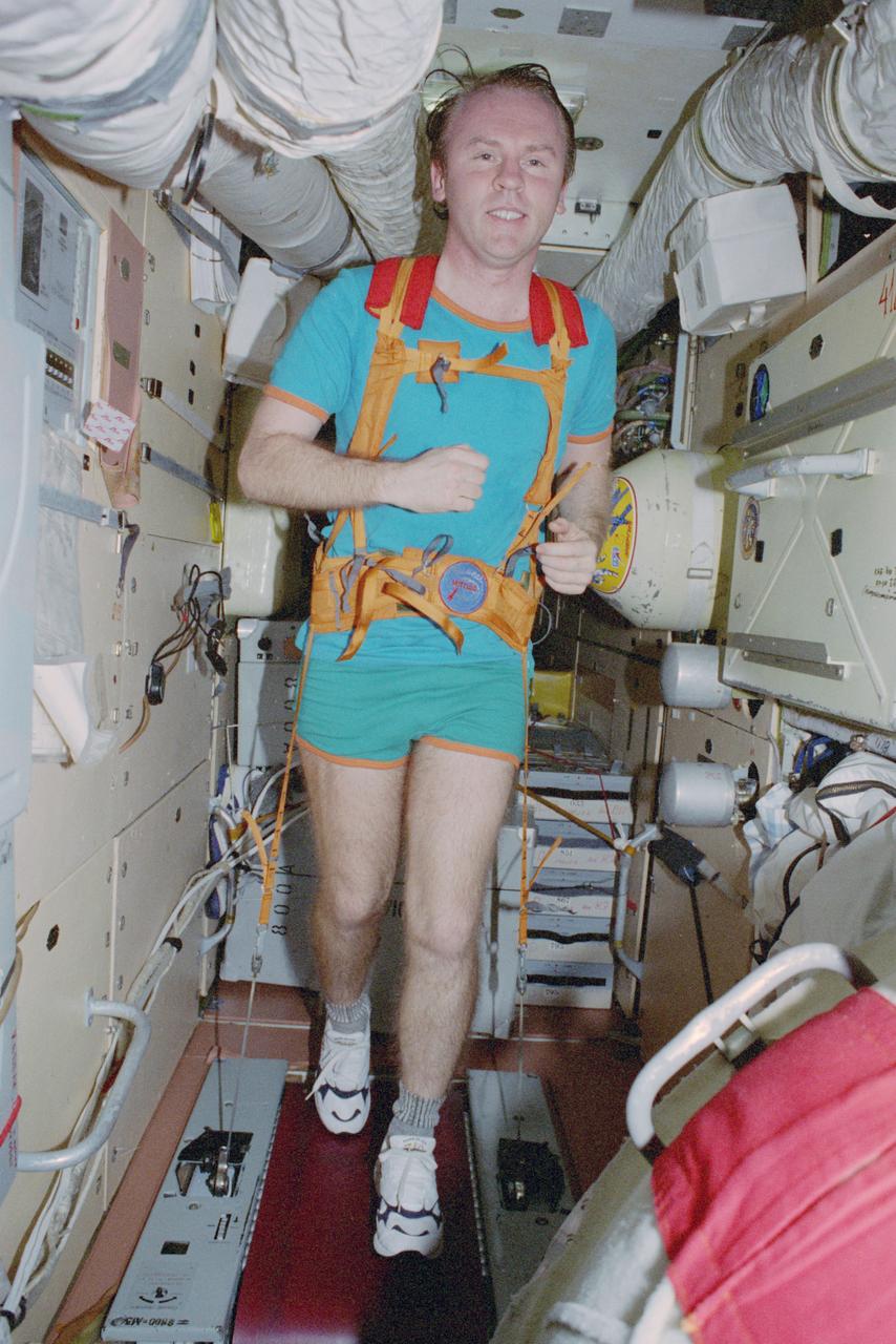 STS091-375-011 (2-12 June 1998) --- Andrew S.W. Thomas makes a treadmill run onboard the Kristall module before joining the STS-91 crew for a journey home that will complete 141 days in space for the NASA astronaut.  Thomas is the final of seven NASA astronauts assigned to indvidual long-duration stays aboard Russia's Mir space station as cosmonaut guest researchers.  Photo Credit: National Aeronautics and Space Administration (NASA) and the Russian Aviation and Space Agency.