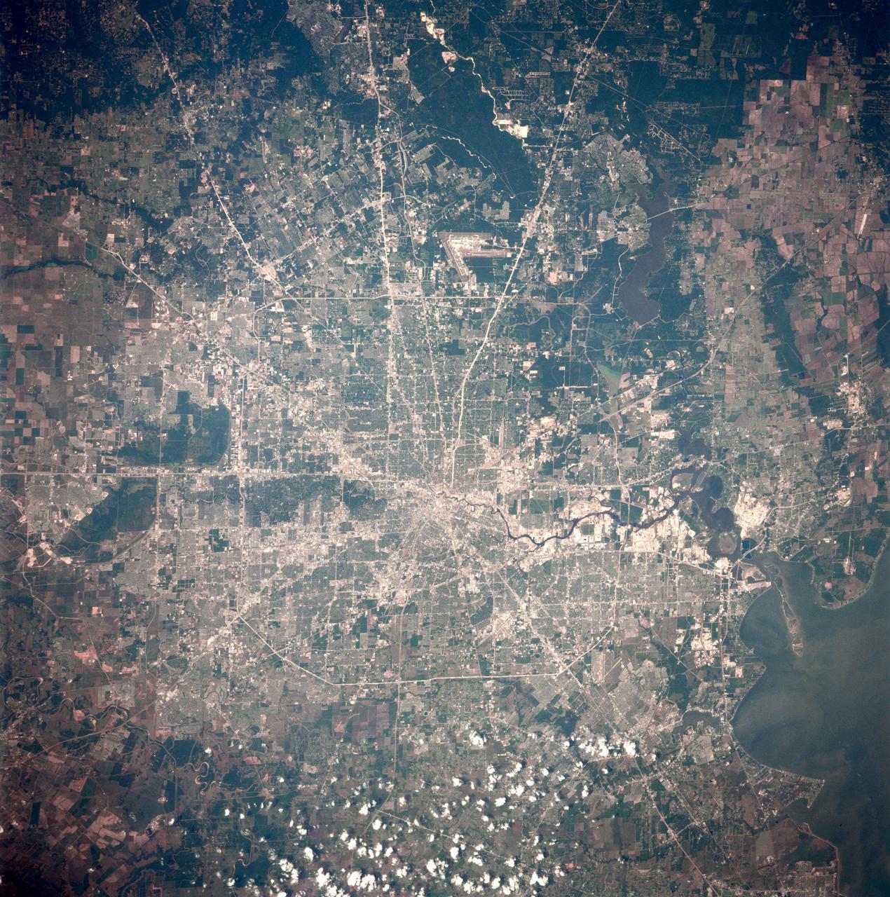 STS091-707-015 (2-12 June 1998) --- This nearly vertical photograph of Houston was taken from the Space Shuttle Discovery. Houston is an inland port city, linked by the Houston Ship Channel (partially visible in lower right quadrant) to the Gulf of Mexico and the Intracoastal Waterway at Galveston (out of frame), 51 miles (82 km) southeast. It is the largest city in Texas and was the fourth largest U.S. city when the photo was taken. Built on a flat Gulf Coastal Plain, the city is named for Sam Houston, the first president elect of the Republic of Texas. Near Clear Lake, some 22 miles from the city's downtown area, is the NASA Lyndon B. Johnson Space Center (1961), which is the command post for the flights by U.S. astronauts.
