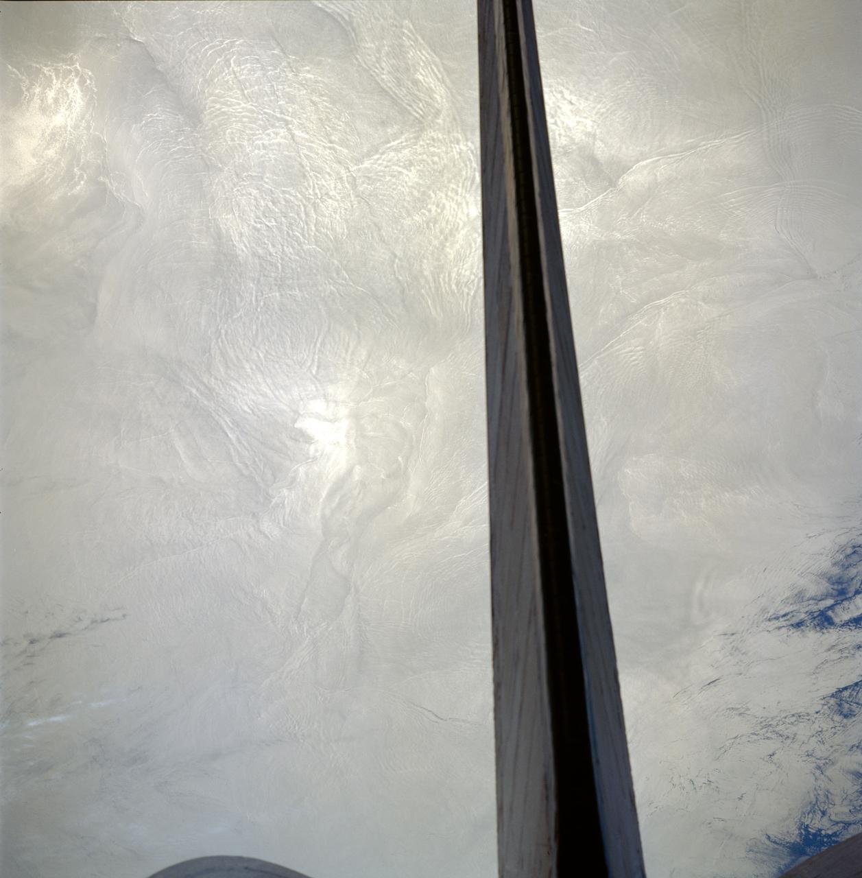 STS091-713-061 (2-12 June 1998) --- The vertical stabilizer of the Space Shuttle Discovery runs through this Atlantic Ocean image made from its crew cabin.  Many sets of internal waves are seen in the 70mm frame traveling through an area off the Atlantic coast of Nova Scotia, Canada.  There are seven sets that run perpendicular to each other.  Internal waves are tidally induced and travel below the surface of the ocean along a density change which occurs often around 150 feet deep. According to NASA scientists studying the STS-91 collection, the waves are visible because, as the wave action smoothes out the smaller waves on the surface, the manner in which the sun is reflected is changed.