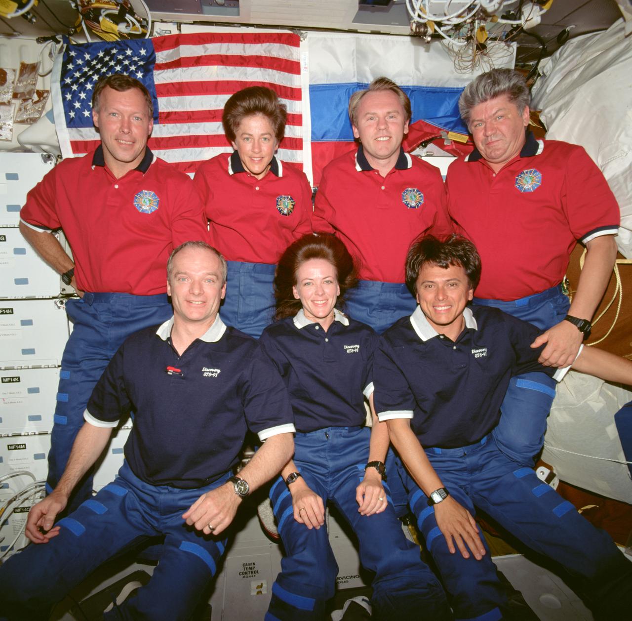 STS091-718-010 (2-12 June 1998) ---  Six plus one equals seven, as the STS-91 crew is joined by Andrew S.W. Thomas (second right, top row) for its traditional inflight crew portrait aboard the Space Shuttle Discovery.  Thomas had earlier joined the NASA crew following a four-month stay aboard Mir.  The crew includes: bottom, from the left,  Charles J. Precourt, mission commander; Janet L. Kavandi, mission specialist; and Franklin R. Chang-Diaz, payload commander; and top, from the left, Dominic C. Gorie, pilot; along with mission specialists Wendy B. Lawrence, Thomas and Valery V. Ryumin.  Ryumin represents the Russian Aviation and Space Agency.
